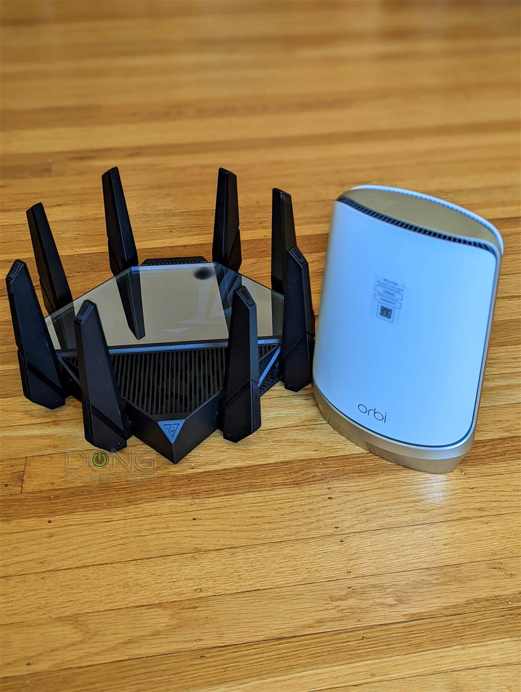 Netgear Orbi RBRE960 Standalone Router Review: Overpriced and Handicapped 4 Asus GT-AXE16000 vs. Netgear Orbi RBKE960: The Asus router is much bulkier than the Netgear counterpart.